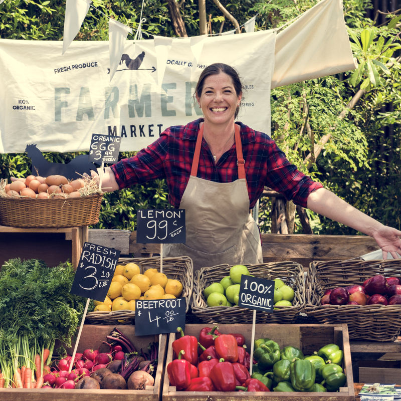 photo of woman running a fruit stand