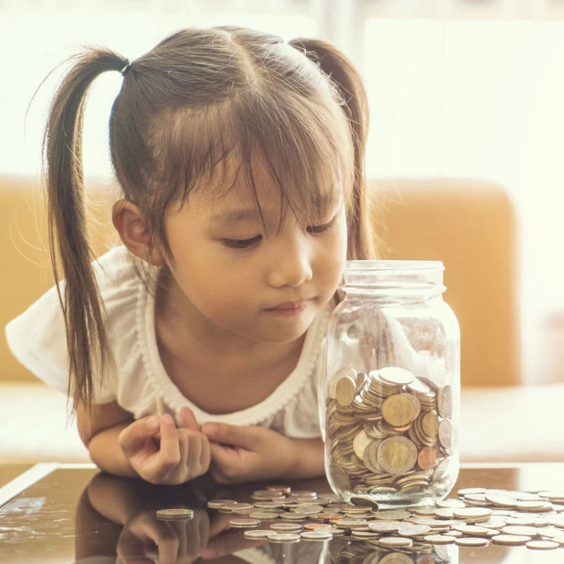 photo of girl and coin jar
