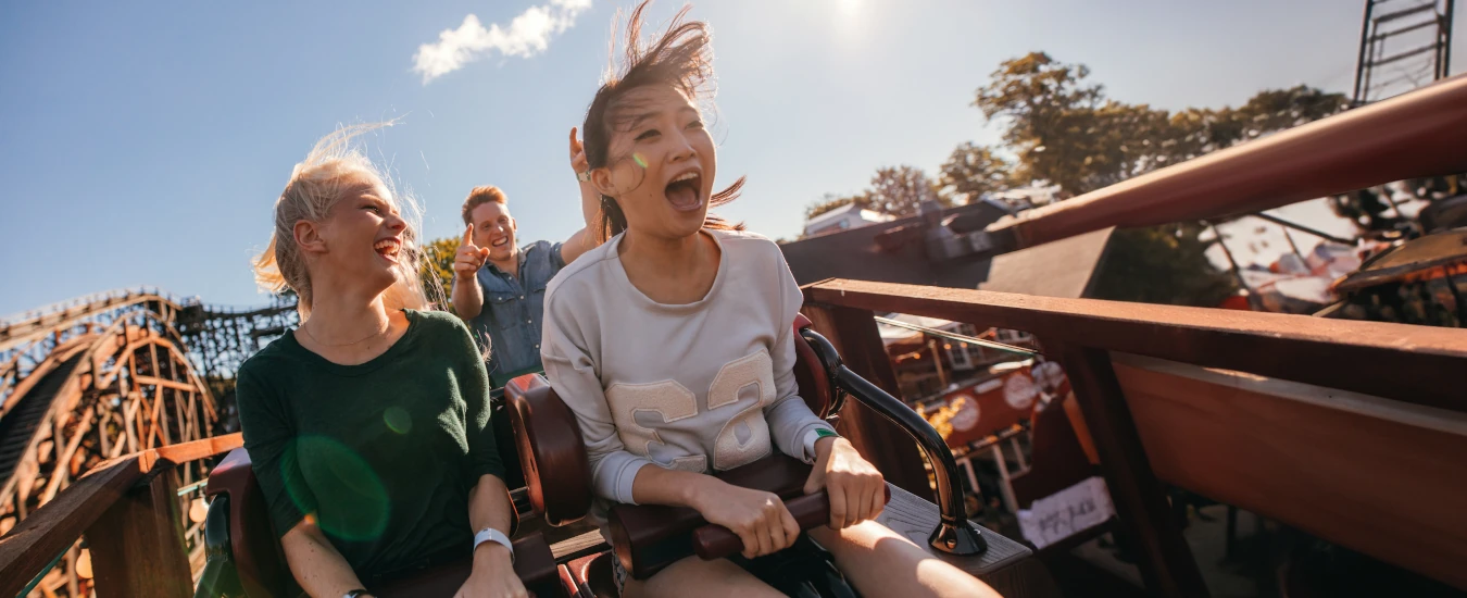 Two young women on a roller coaster