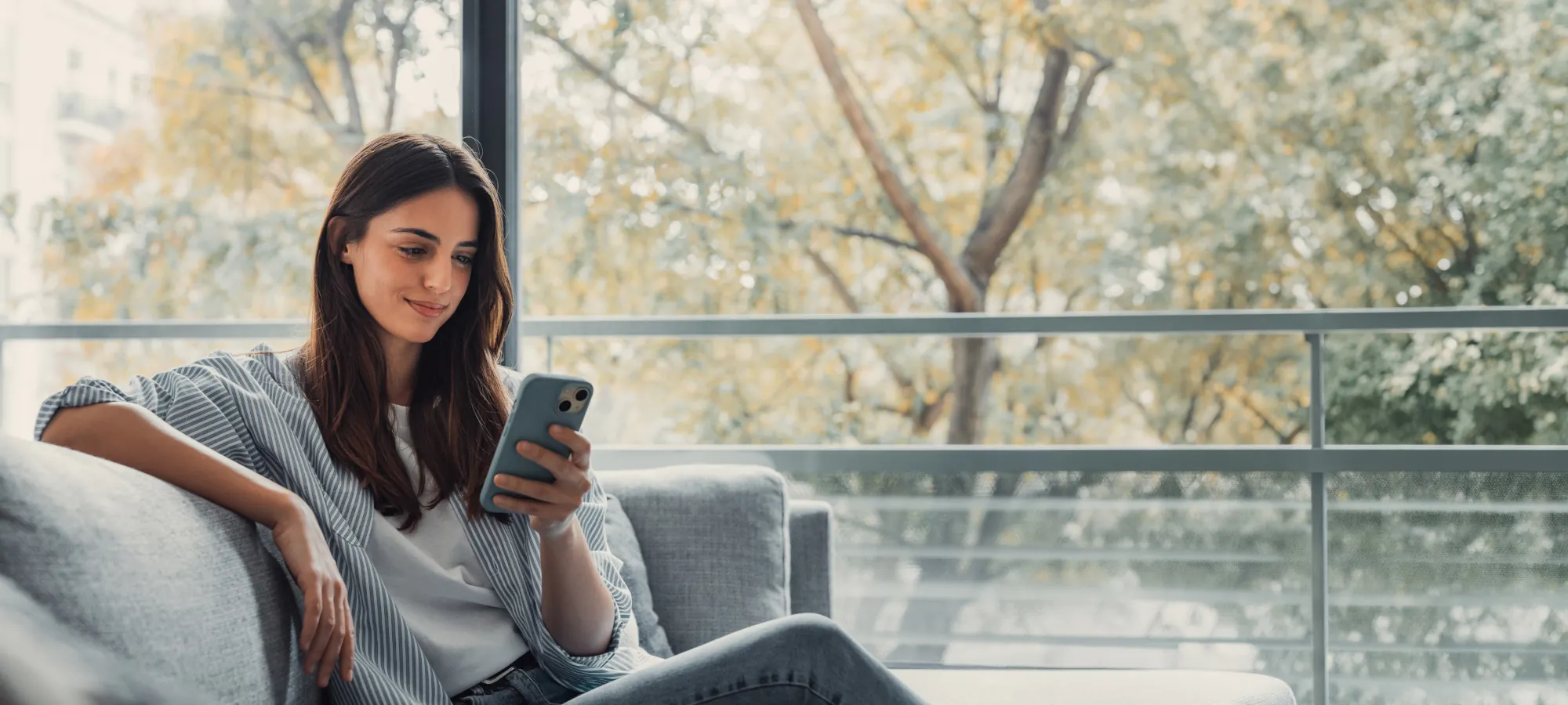 A woman checks her high-yield savings account balance with a mobile device.