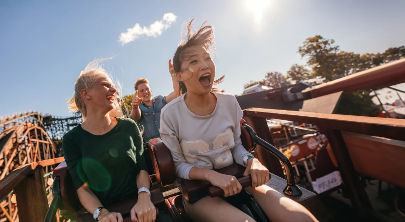 Two young people on a roller coaster
